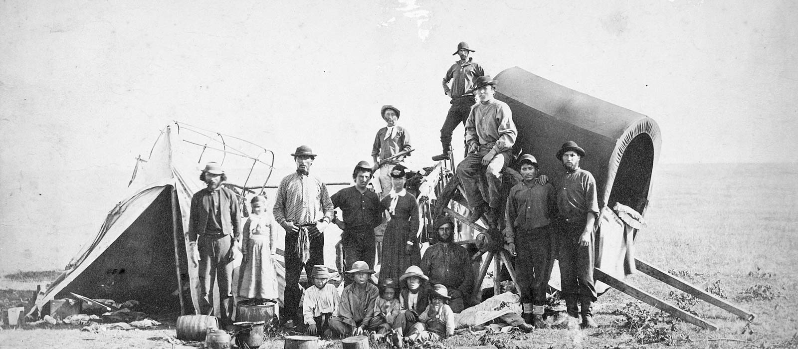 Métis freighting brigade with Red River cart and canvas lodge on the open prairie